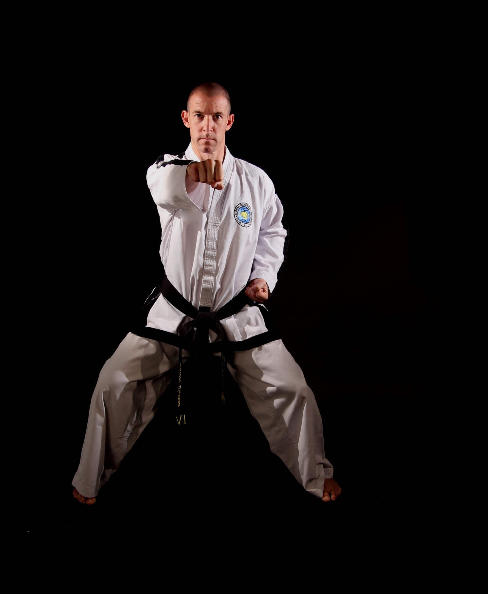 Mr. Gareth Curran, VI Degree, performing a punch in a Taekwon-Do stance